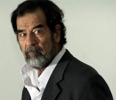 A handout photograph released by the Iraqi Special Tribunal on August 23, 2005, shows former Iraqi president Saddam Hussein being questioned by Chief Investigative Judge Raid Juhi, at an undisclosed location.